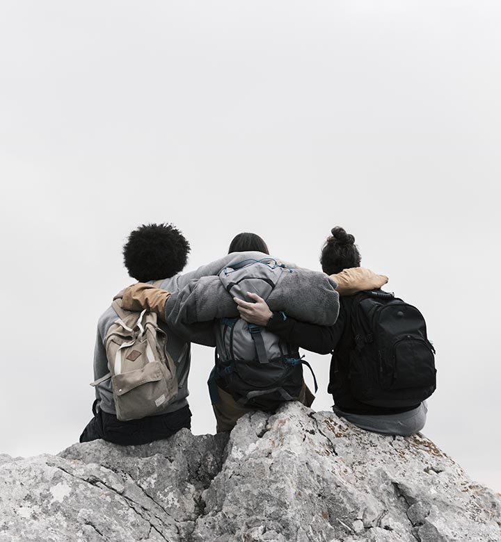 Sitting people on a mountain rock again